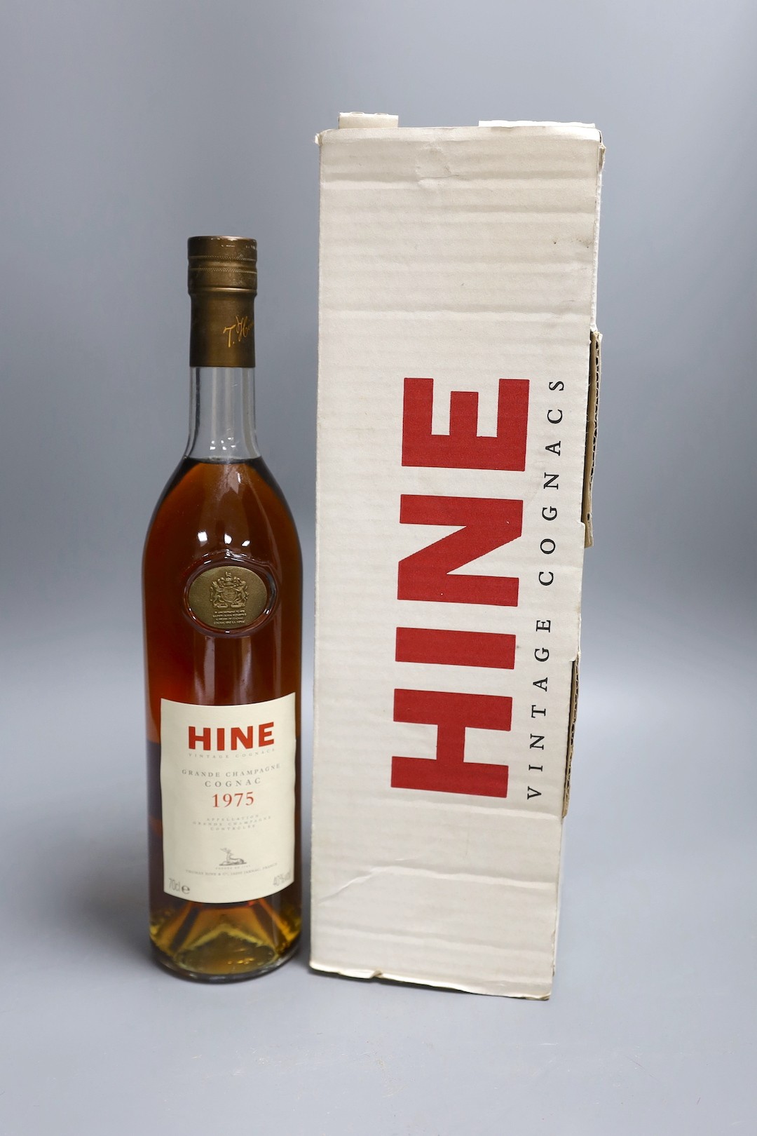 One bottle of Hine Grand Champagne Cognac, 1975. Original cardboard box.
